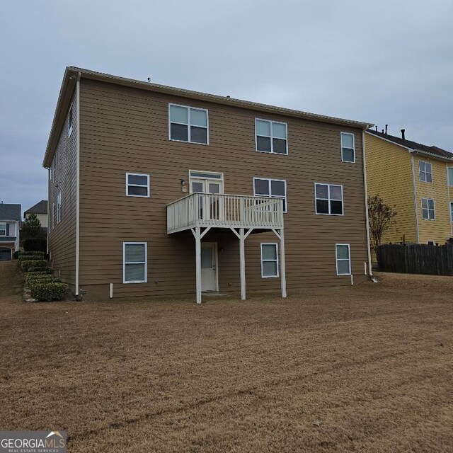 rear view of house featuring a deck