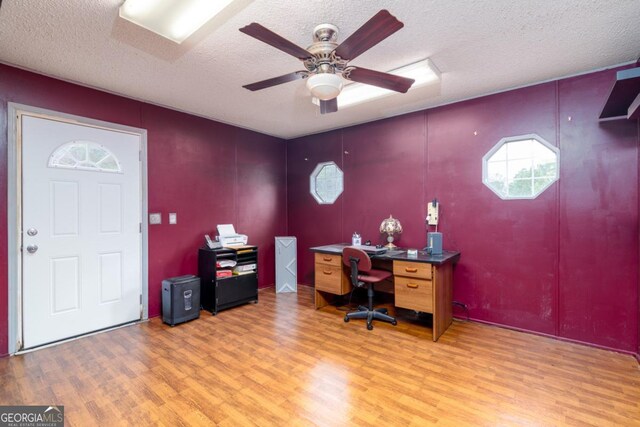 office featuring hardwood / wood-style floors, ceiling fan, and a textured ceiling