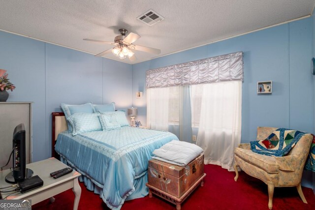 bedroom with ceiling fan and a textured ceiling