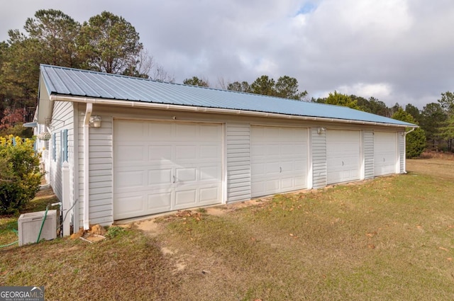 garage featuring a lawn