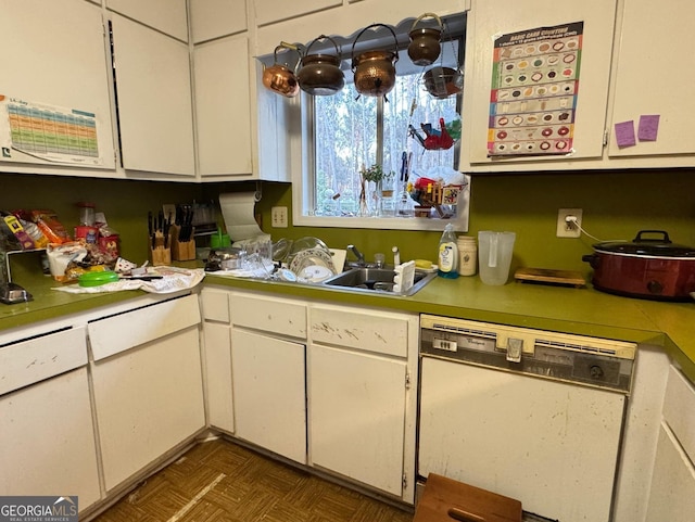 kitchen with dishwasher, dark parquet floors, white cabinets, and sink