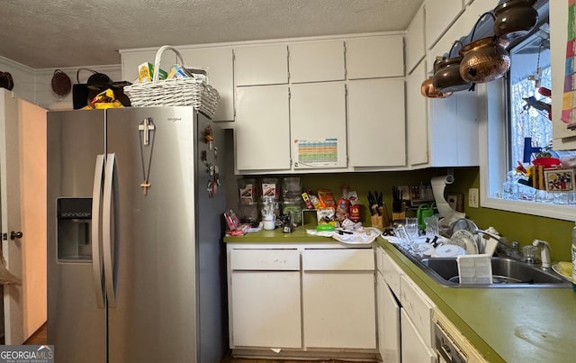 kitchen featuring a textured ceiling, white cabinetry, sink, and stainless steel refrigerator with ice dispenser