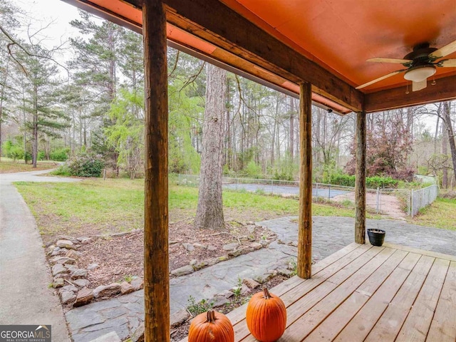 exterior space with ceiling fan and a lawn