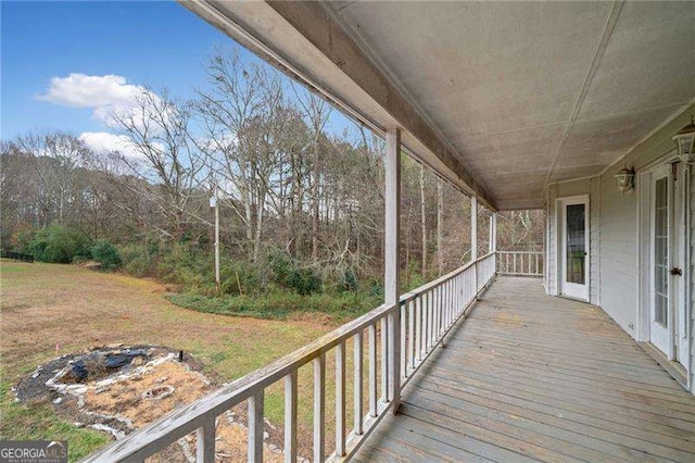 wooden deck featuring a yard