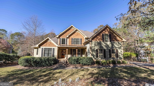 view of front of home featuring a porch and a front lawn