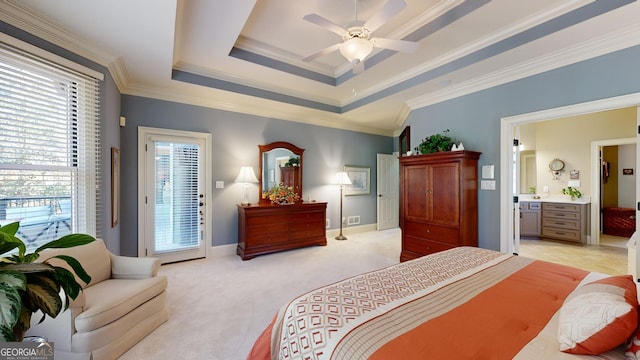 carpeted bedroom featuring ornamental molding, access to outside, a tray ceiling, ceiling fan, and connected bathroom