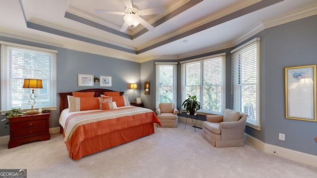 bedroom featuring carpet flooring, a raised ceiling, ceiling fan, and ornamental molding