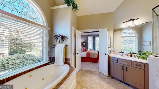 bathroom with vanity and tiled bath