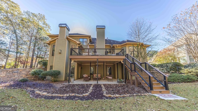 back of house featuring a patio and a wooden deck