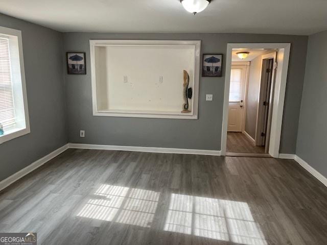 spare room with dark hardwood / wood-style flooring