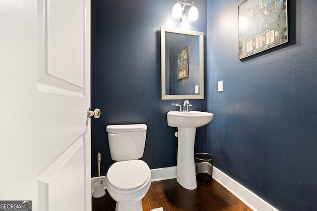 bathroom with toilet and wood-type flooring