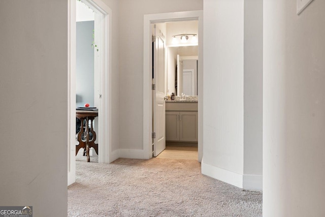 hallway featuring light carpet