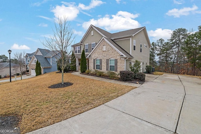 147 Stargaze Rdg, Canton, GA 30114 - traditional home featuring driveway, brick siding, and a front lawn