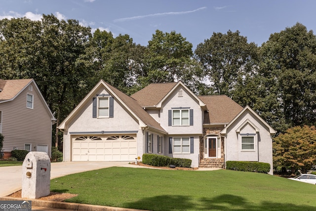 front of property featuring a front lawn and a garage