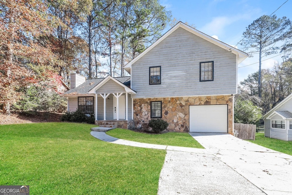 view of front property featuring a front yard and a garage