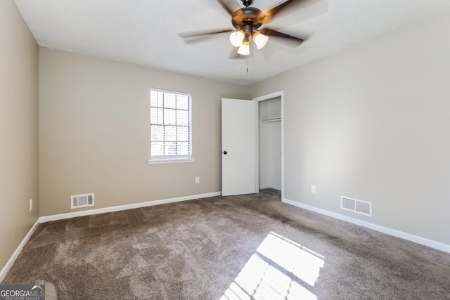 unfurnished bedroom with ceiling fan, a closet, and carpet