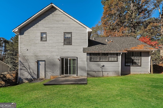 back of house with a patio area and a lawn