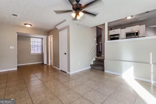 interior space featuring ceiling fan and light tile patterned floors