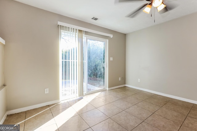 tiled empty room featuring ceiling fan