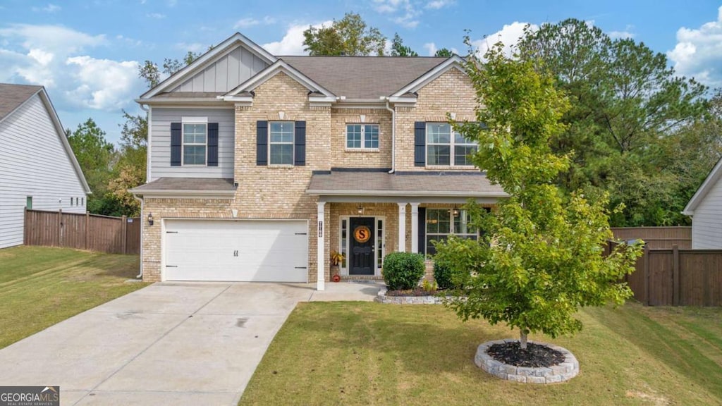 view of front of property with a garage and a front lawn