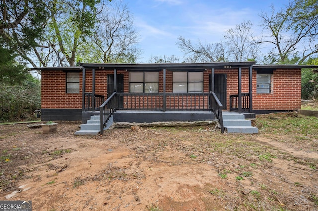 single story home featuring covered porch