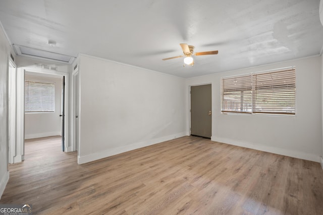 unfurnished room with ceiling fan, light hardwood / wood-style floors, and ornamental molding