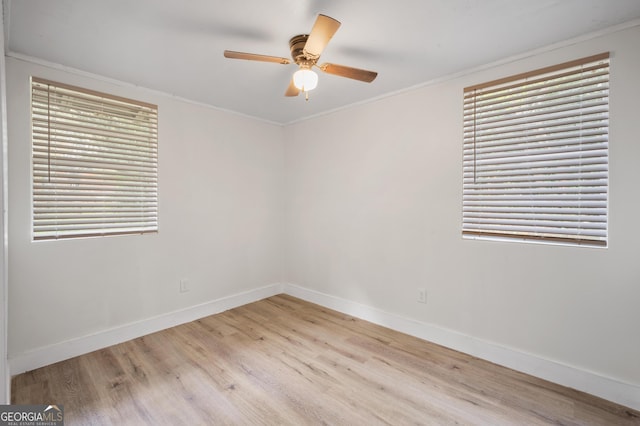empty room with light hardwood / wood-style flooring, ceiling fan, and crown molding