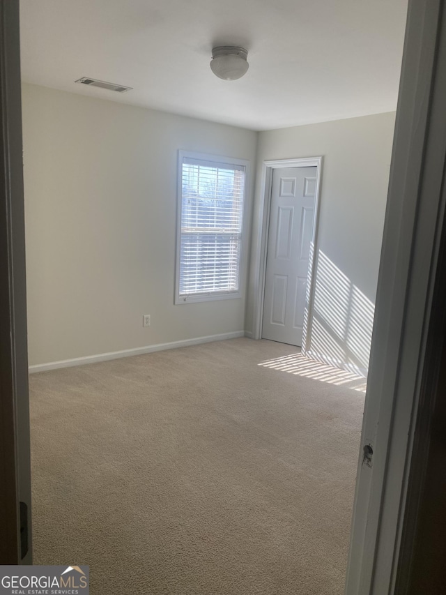 spare room with light carpet