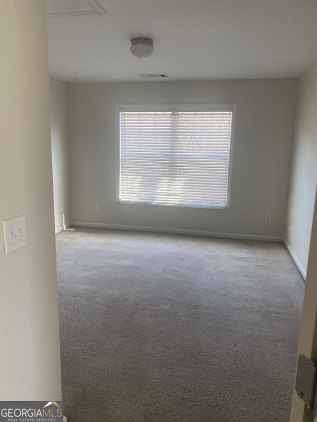 spare room with light colored carpet