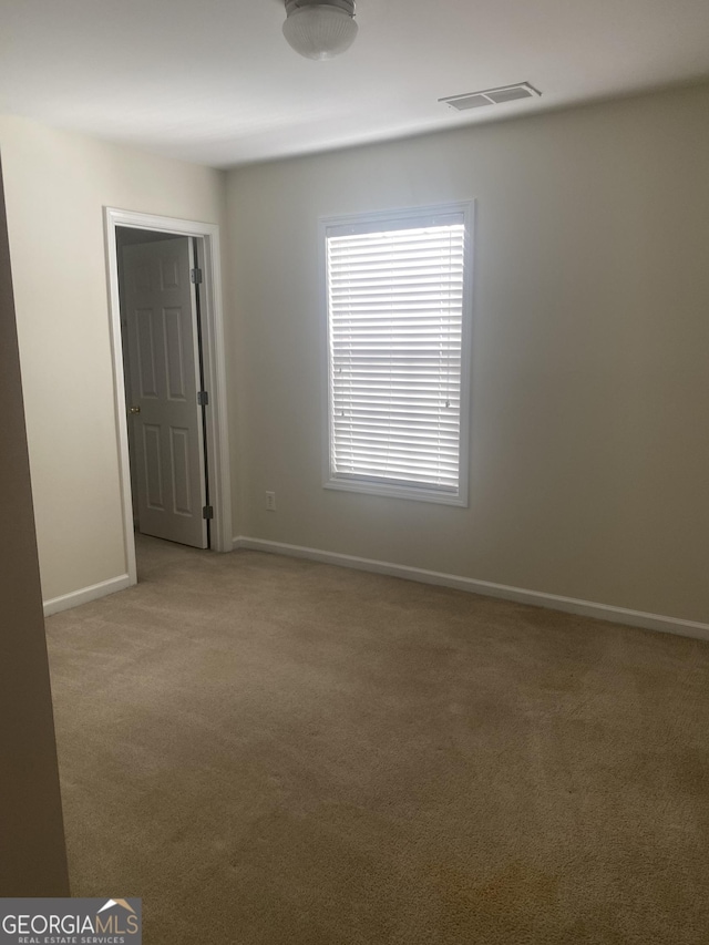 unfurnished room with light carpet