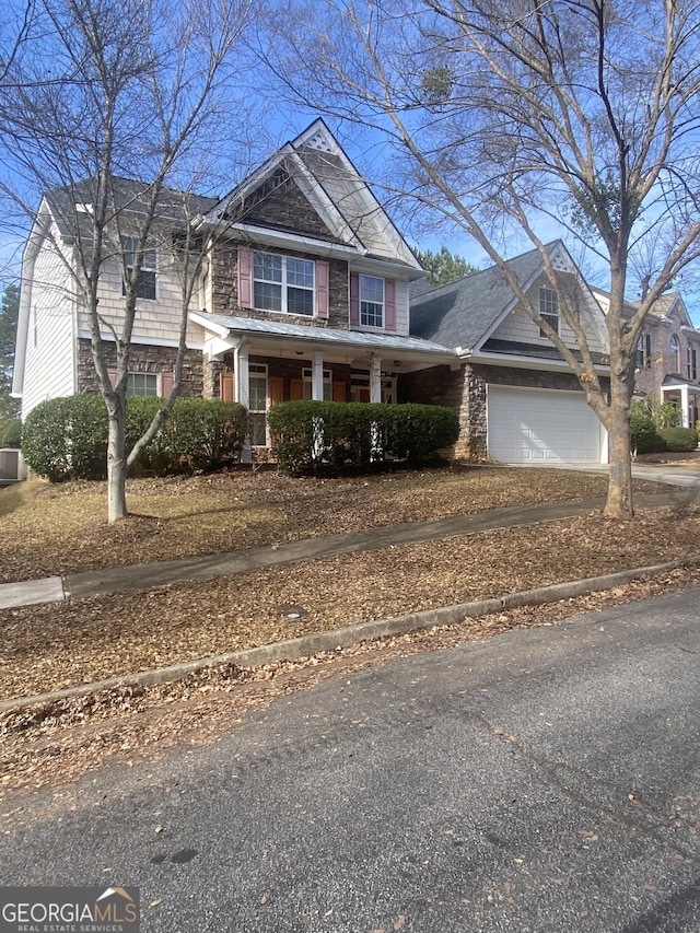 view of front of property with covered porch and a garage