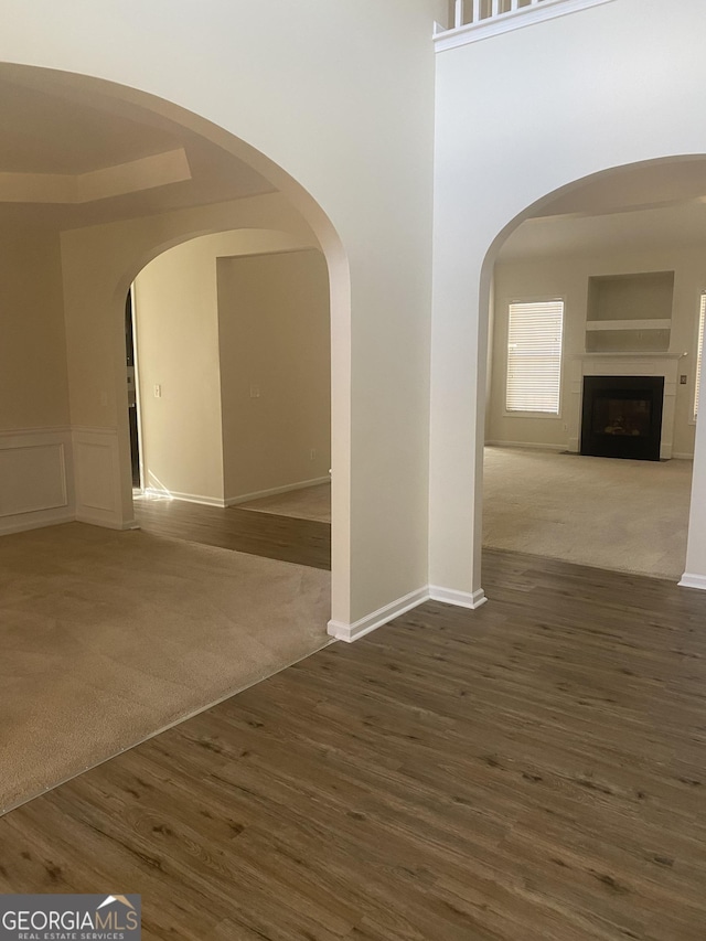 unfurnished room with dark wood-type flooring