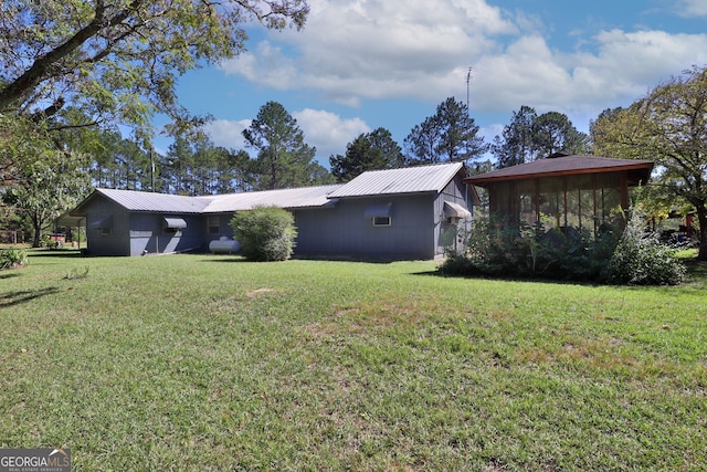 view of home's exterior featuring a yard and a sunroom