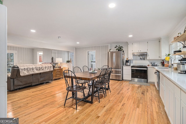 dining room featuring sink and light hardwood / wood-style floors