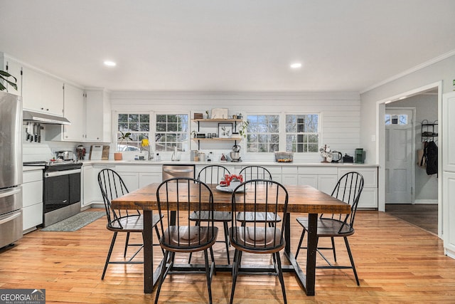 dining room featuring ornamental molding and light hardwood / wood-style flooring