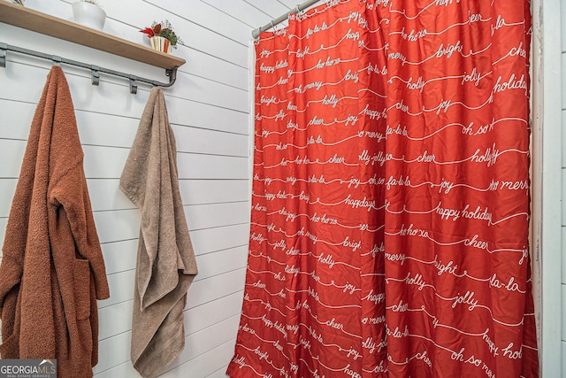 bathroom featuring wood walls