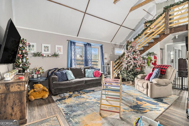 living room with wood-type flooring and vaulted ceiling