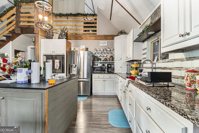 kitchen featuring stainless steel appliances, an inviting chandelier, dark hardwood / wood-style floors, pendant lighting, and white cabinets