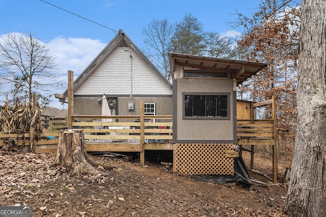 back of property with a wooden deck