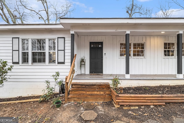 view of exterior entry with a porch