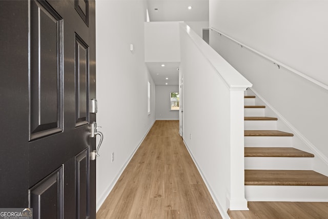 unfurnished living room with hardwood / wood-style flooring and sink