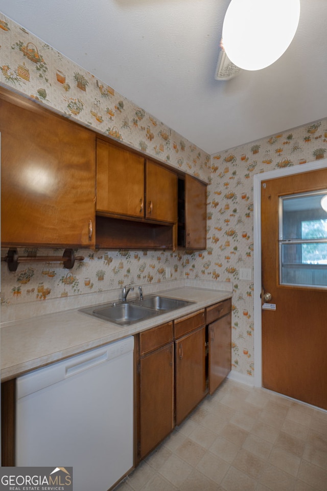 kitchen featuring white dishwasher and sink