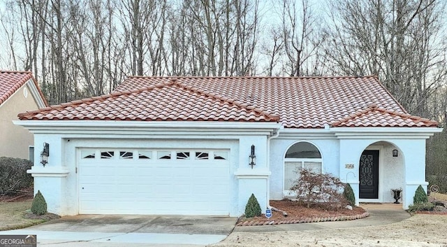 mediterranean / spanish house featuring a garage