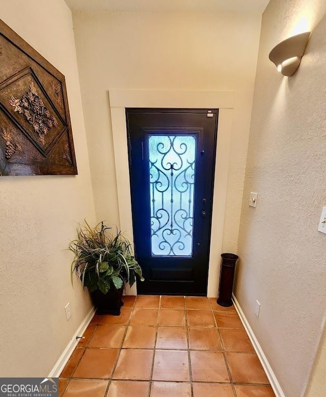 entryway with light tile patterned floors