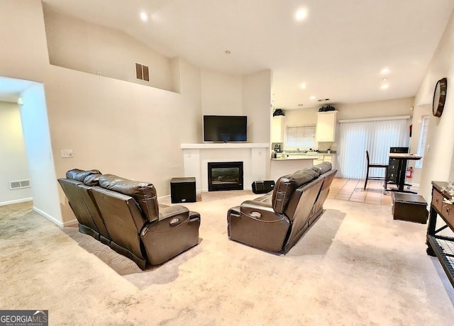 carpeted living room with vaulted ceiling