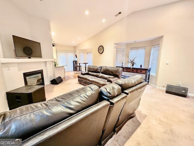 carpeted living room featuring lofted ceiling