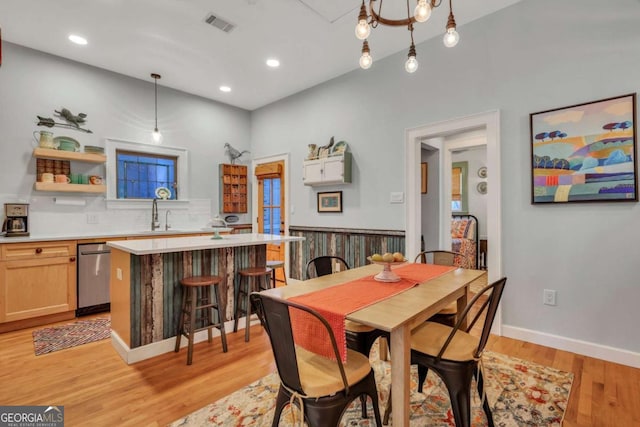 dining area with light wood-type flooring and sink