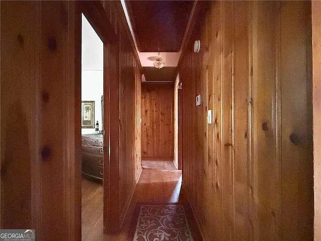 hall featuring wooden walls