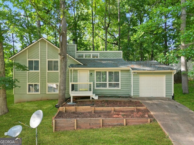 view of front of property with a front yard and a garage