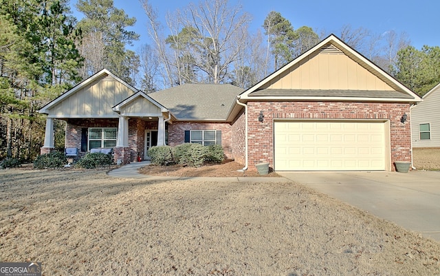 craftsman-style house featuring a garage, brick siding, driveway, and roof with shingles